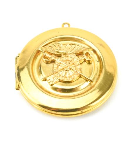 Estate US Military Quartermaster Locket Pendant: Estate US Military Quartermaster Locket Pendant. Scene of eagle with spread wings along with a crossed sword and skeleton key. Measures just over 1.25 inches in length.