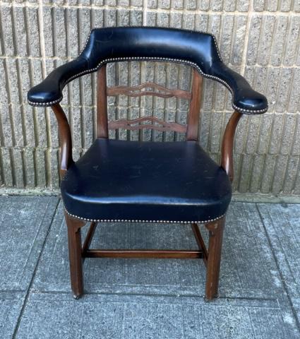 Chesterfield Style Black Leather Armchair: Chesterfield Style Black Leather Armchair. Having a solid wood frame with carved mid rail, leather upholstery, and nailhead head trim. On castors. Measures 32.5 inches x 29 inches x 22 inches x 17.5 i