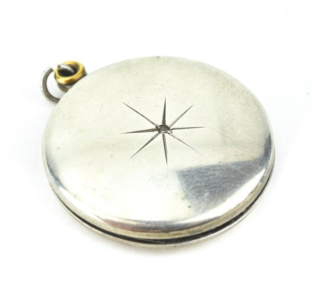 Antique Sterling Locket w Starburst at Center: Antique Sterling Silver Locket Necklace Pendant w Starburst at Center. Measures 1.25 inches in length.