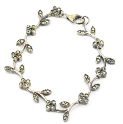 Sterling Silver & Marcasite Floral Motif Bracelet: Sterling Silver & Marcasite Floral Motif Bracelet. Articulated. Measures jut over 7 inches in length.