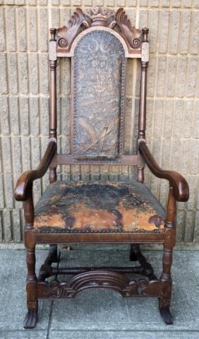 Antique Baroque Revival Tooled Leather Armchair: Antique Baroque Revival Tooled Leather Armchair. Armchair with tooled leather back and seat, scrolled arms, and carved stretcher, rising on block and turn legs with Spanish feet. Measures 50 inches x 