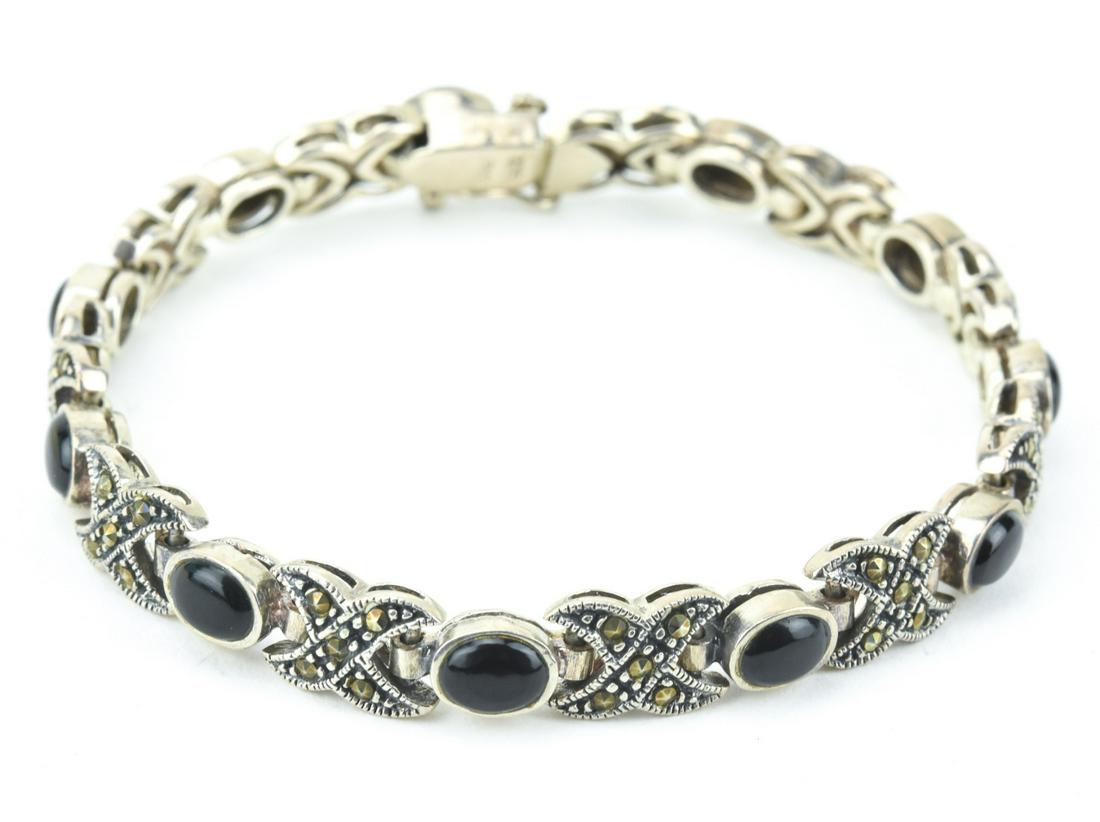 Sterling Silver Marcasite & Black Onyx Bracelet: Sterling Silver Marcasite & Black Onyx Bracelet. Articulated panel bracelet. Hallmarked. Measures 7.5 inches in length.