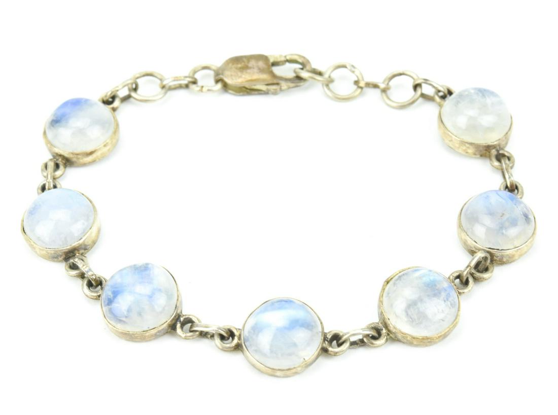 Sterling Silver & Bezel Set Moonstone Bracelet: Sterling Silver & Bezel Set Moonstone Bracelet. Hallmarked. Set with seven bezel set cabochon moonstones. Measures 7.5 to 8.25 inches in length.