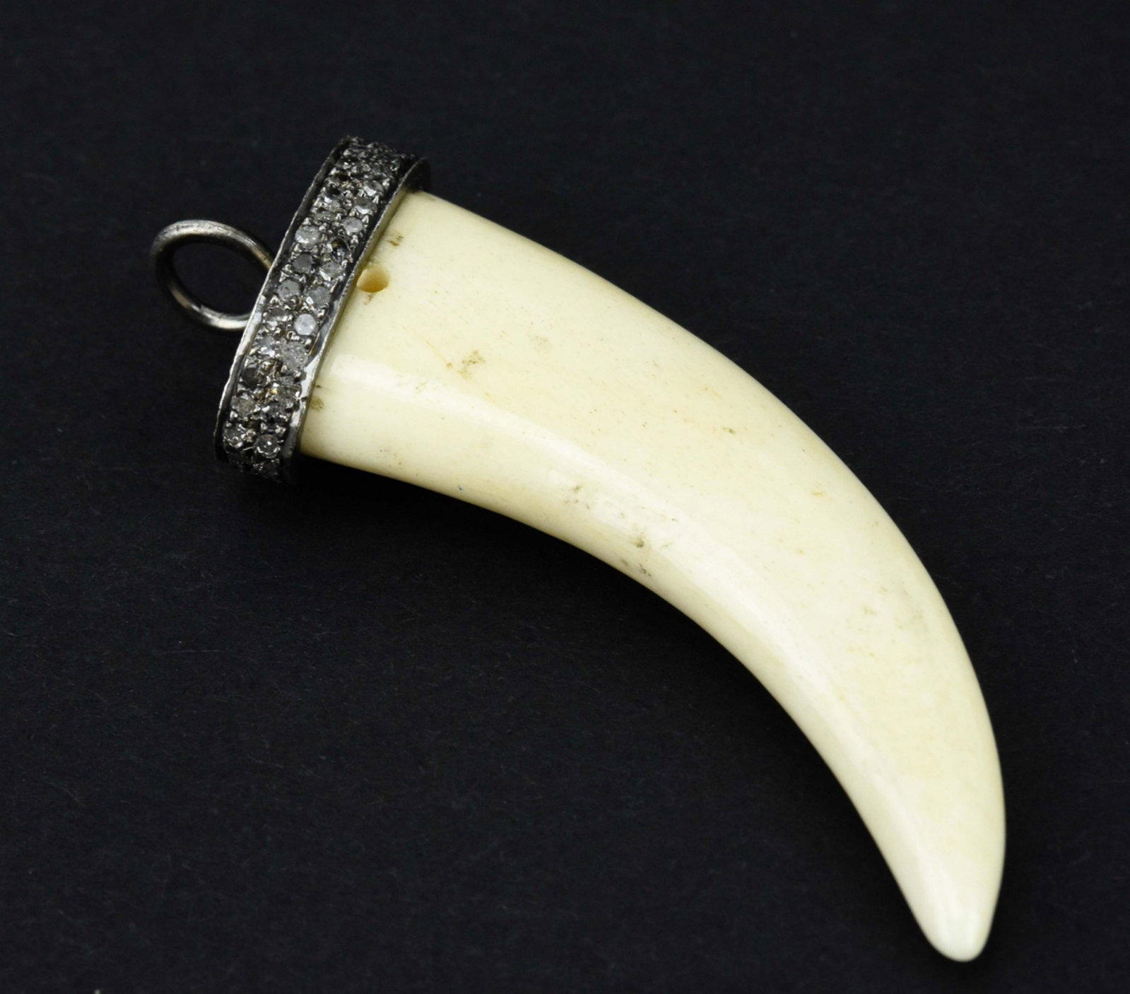 Pave Diamond Set & Sterling Silver w Bone Pendant: Pave Diamond Set & Sterling Silver w Bone Pendant. Horn design carved bone, top with sterling silver mount and bail set with two rows of pave diamonds. Measures 2 inches in length.