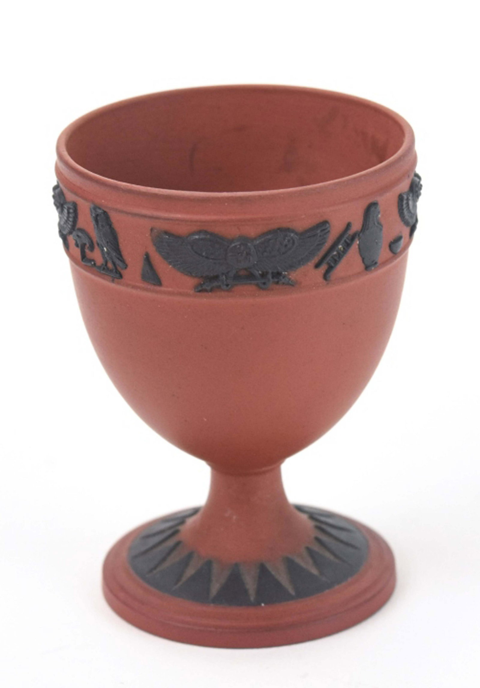 Antique Wedgwood Egyptian Revival Egg Cup: Antique Wedgwood Egyptian Revival Egg Cup. Basalt jasperware egg cup with Egyptian style motif band around the top. Marked on bottom. Measures 2.5 inches in height.