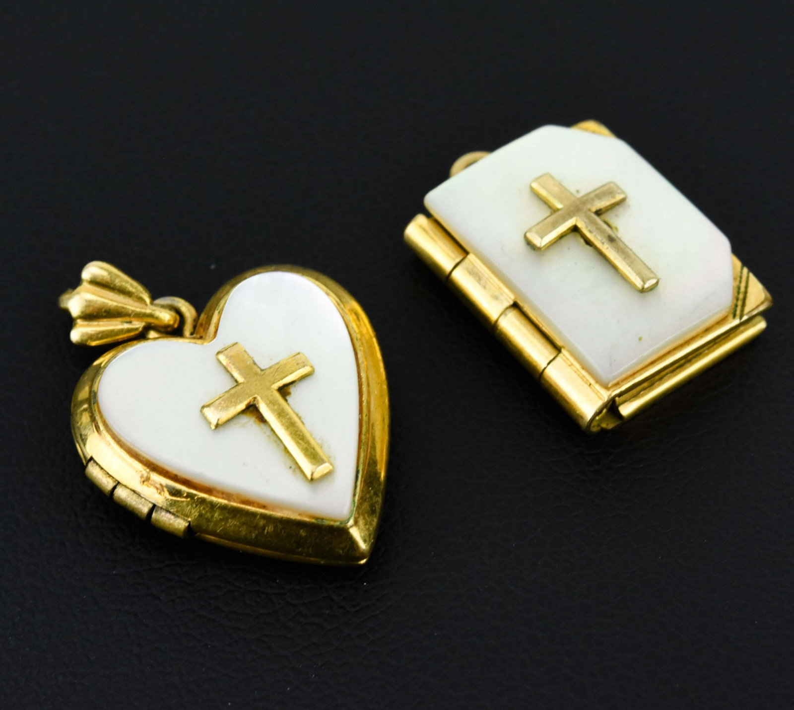Vintage Mother of Pearl w Cross Locket Pendants: Two Vintage Mother of Pearl w Cross Locket Pendants. Gold filled settings with mother of pearl panels that are mounted with crosses. Each approximately 1/2 an inch in length plus the bail.