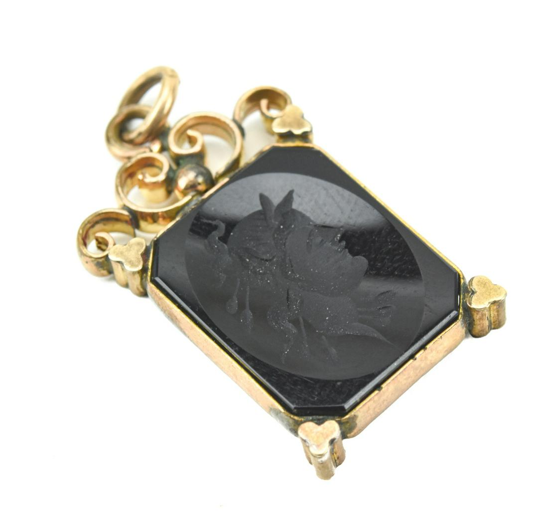 Antique 19th C Carved Black Onyx Intaglio Pendant: Antique 19th C Carved Black Onyx Intaglio Pendant. Greco Roman solider in gold filled frame. Measures 1.25 inches in length, plus the bail.