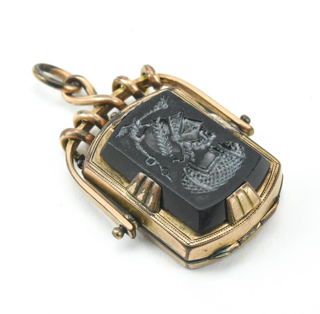 Antique19th C Spinning Locket Necklace Pendant: Antique19th C Spinning Locket Necklace Pendant. With intaglio on front. Gold filled setting. Measures just under 2 inches in length.