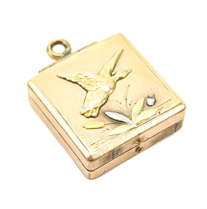 Antique 19th C Chinoiserie Shakudo Locket Pendant: Antique 19th C Chinoiserie Shakudo Locket Pendant. Gold filled locket necklace pendant with gold and silver applied scene on front of bird and plants. Measures just over 1 inch in length.