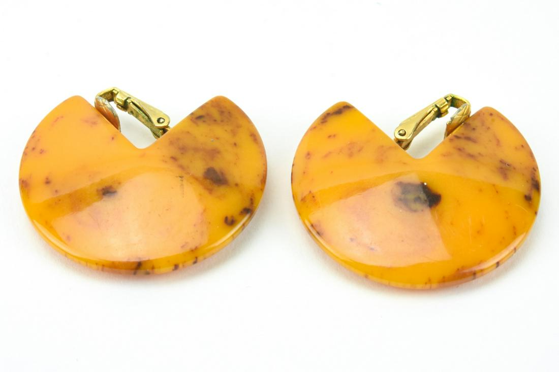 Pair of Vintage Faux Amber Bakelite Earrings: Pair of Vintage Faux Amber Bakelite Earrings. Clip ons. Each measures 1.5 inches in diameter.