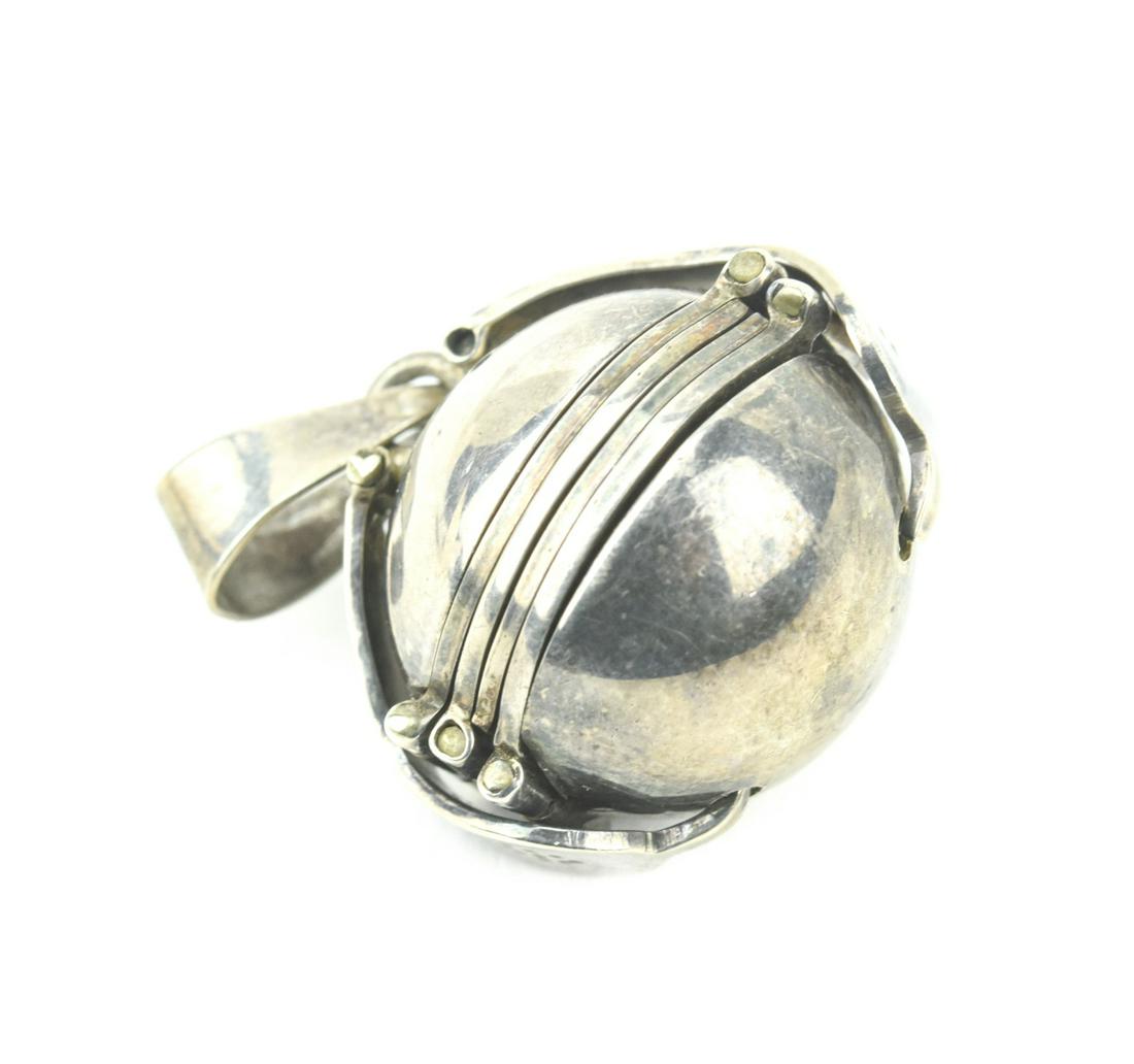 Vintage Sterling Silver Accordion Locket Pendant: Vintage Sterling Silver Accordion Locket Pendant. Opens to hold six round photos. Hallmarked. Measures over 1 inches in length.