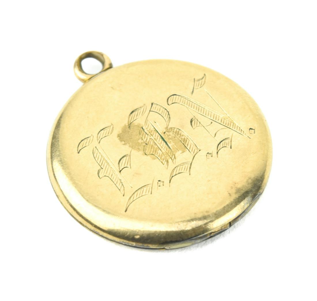 Antique Gold Scrollwork Motif Locket Pendant: Antique Gold Scrollwork Motif Locket Necklace Pendant. Interior is marked GOLD SHELL. Measures 1.25 inches in length.