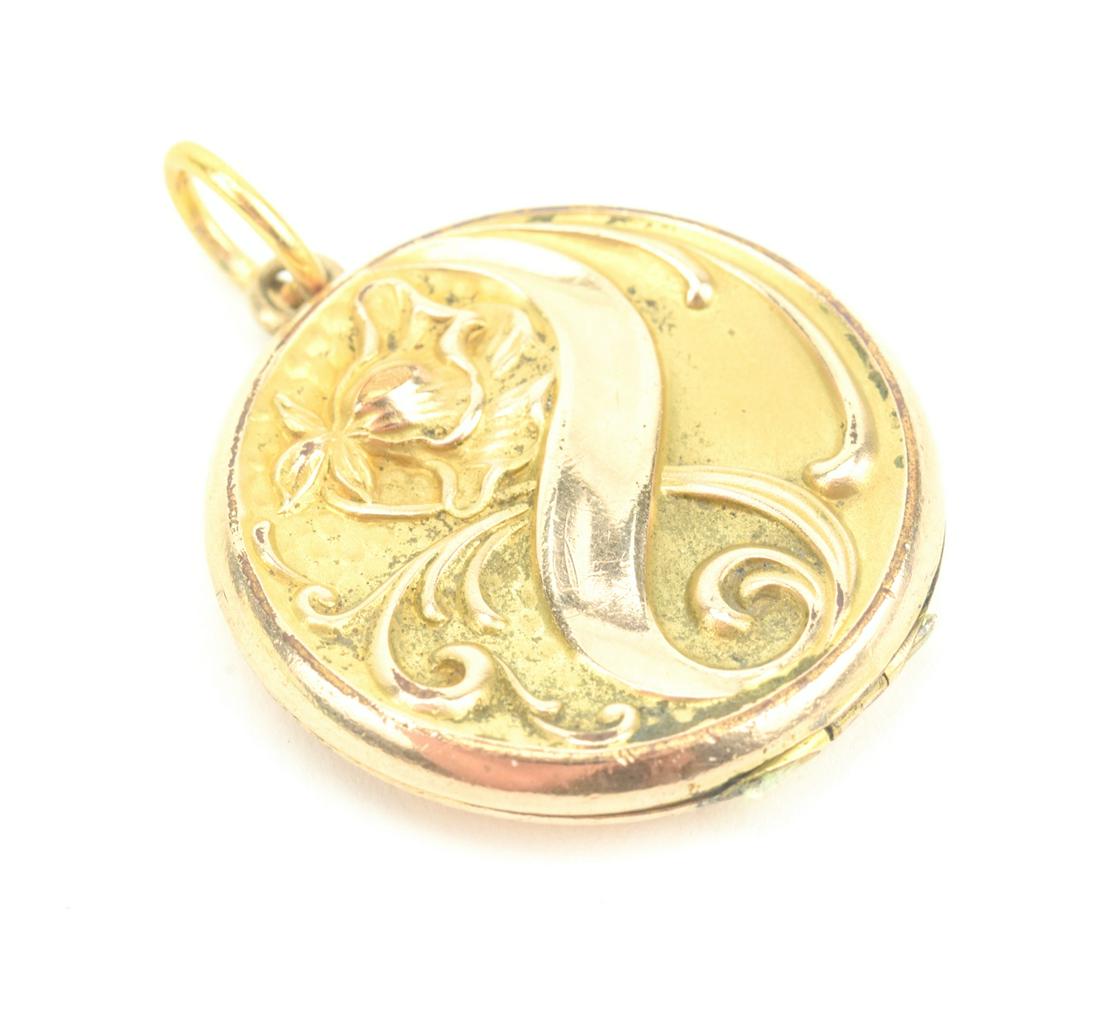Antique C 1900 Gold Filled Art Nouveau Locket: Antique C 1900 Gold Filled Art Nouveau Locket Necklace Pendant. Repousse scene on front with iris flower and scrollwork. Measures 1.5 inches in length.
