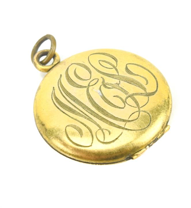Antique Art Nouveau Era Gold Filled Locket Pendant: Antique Art Nouveau Era Gold Filled Locket Pendant. Having an Art Nouveau style font to the multi letter monogram on the front. Measures 1.25 inches in length.