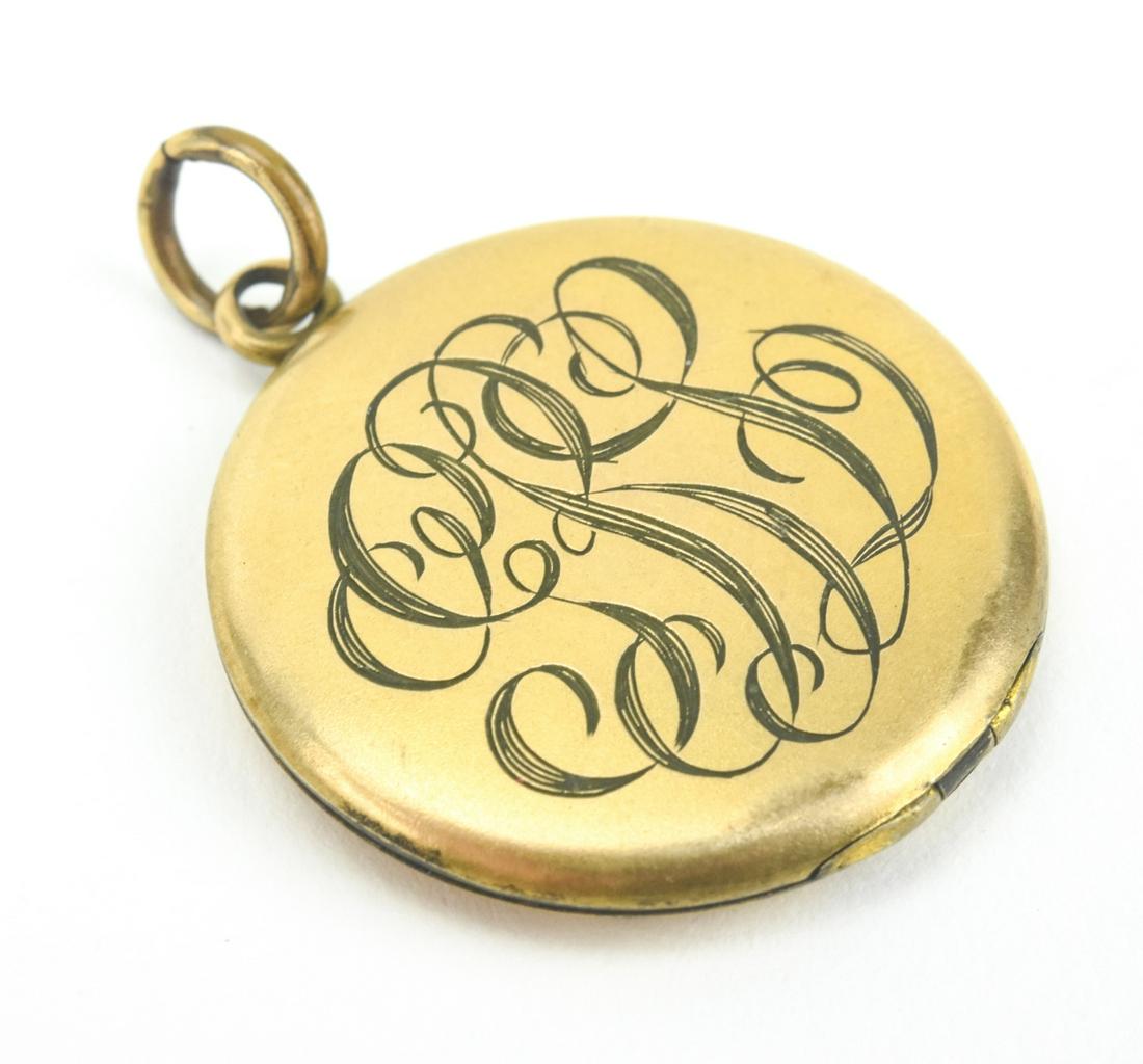 Antique Art Nouveau Era Gold Filled Locket Pendant: Antique Art Nouveau Era Gold Filled Locket Pendant. Having an Art Nouveau style font to the multi letter monogram on the front. Measures 1.5 inches in length.
