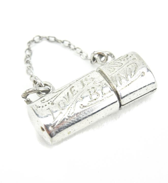 Vintage Sterling " Love is Blind " Locket Pendant: Vintage Sterling " Love is Blind " Locket / Case Pendant. Opens. Measures just over .75 of an inch in length.