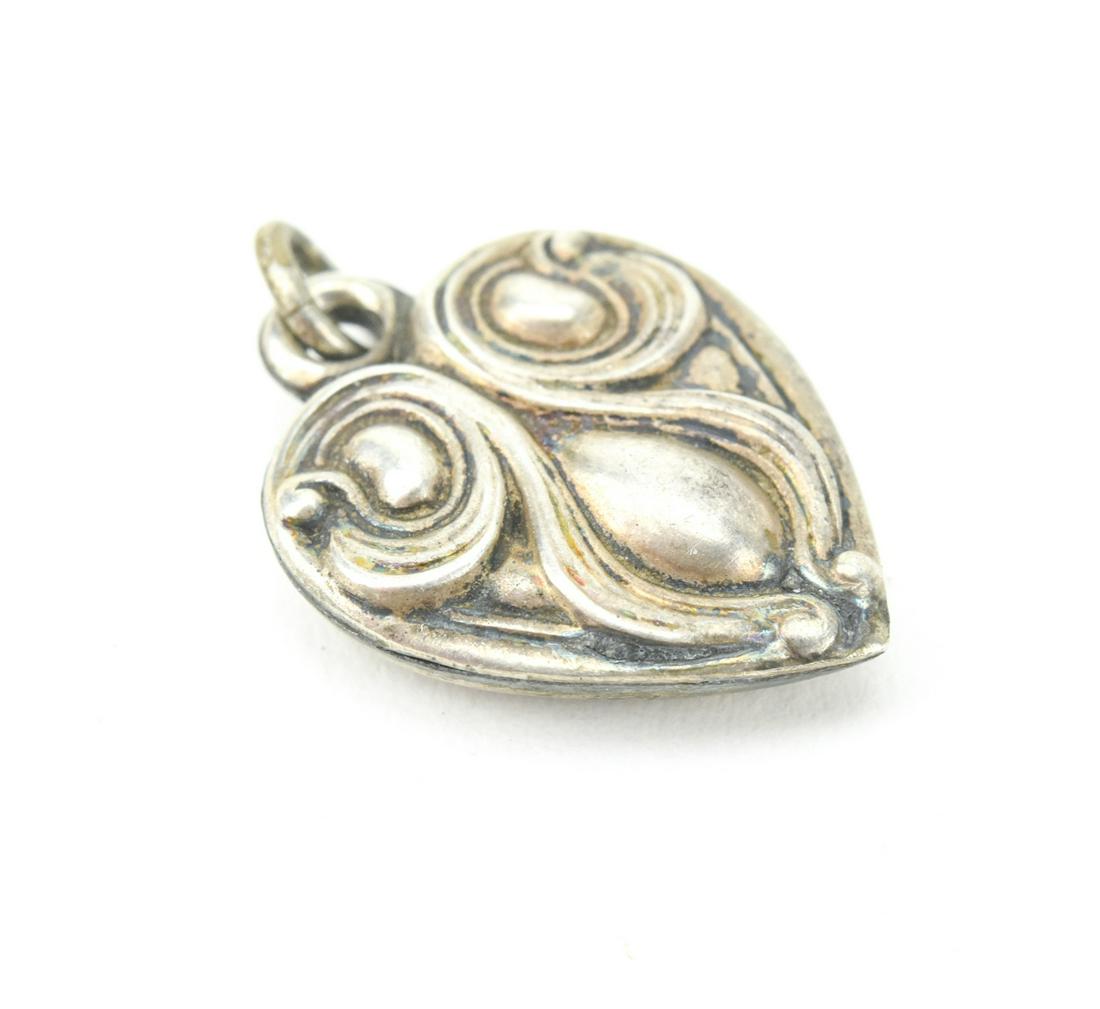 Antique Sterling Art Nouveau Puffy Heart Charm: Antique Sterling Art Nouveau Puffy Heart Charm or Necklace Pendant. Measures approximately .75 of an inch in length.