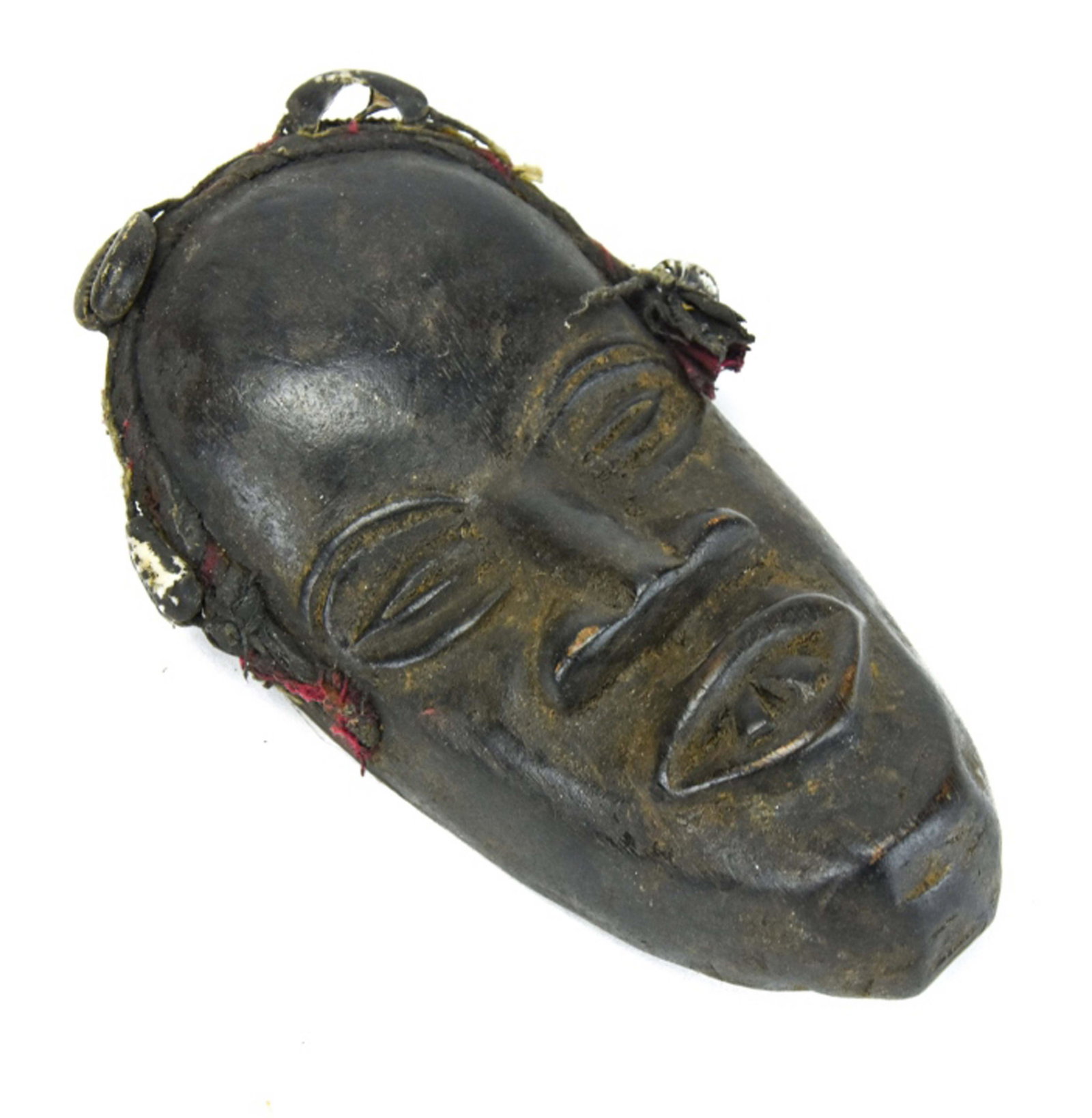 African Carved Tribal Mask: African Carved Tribal Mask. Measures 6 inches x 3 inches x 1.5 inches.