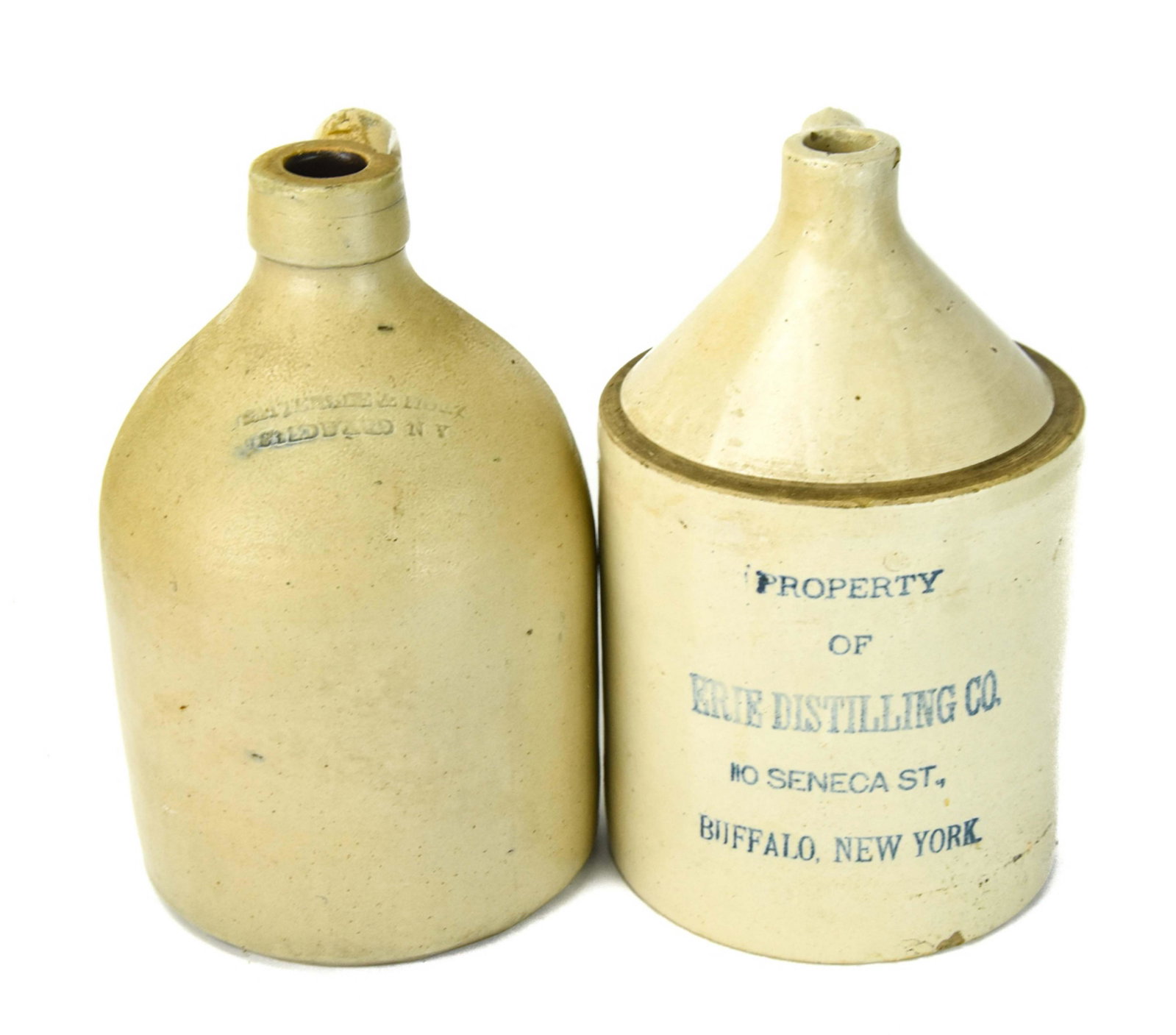 2 Antique Salt Pottery Distillery Jugs w Handles: 2 Antique Salt Pottery Distillery Jugs w Handles Includes Jug From Erie Distilling. 12 inches x 7 inches in diameter.