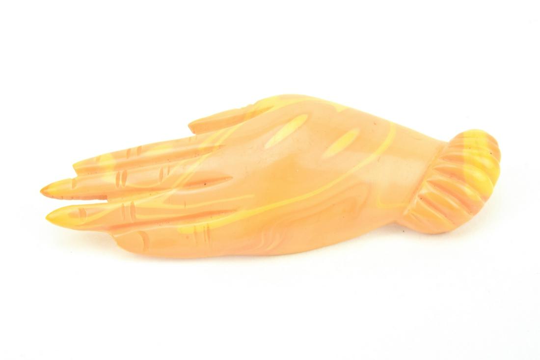 Vintage Faux Amber Bakelite Figural Hand Clasp: Vintage Faux Amber Bakelite Figural Hand Clasp / Button / Pendant. Measures 2 inches in length.