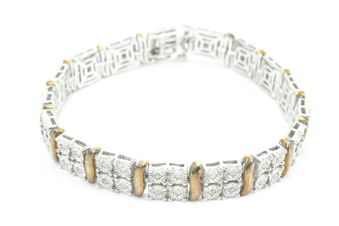Diamond & Sterling Silver Tennis Bracelet: Diamond & Articulated Sterling Silver Tennis Bracelet. Set with 68 diamonds. Measures 7 inches in length.