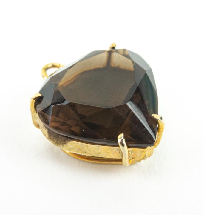 Estate Heart form Smoky Quartz Necklace Pendant: Estate Heart form Smoky Quartz Necklace Pendant. Tests as quartz on the Presidium. Set in gold plated sterling silver. Measures .75 of an inch in length.