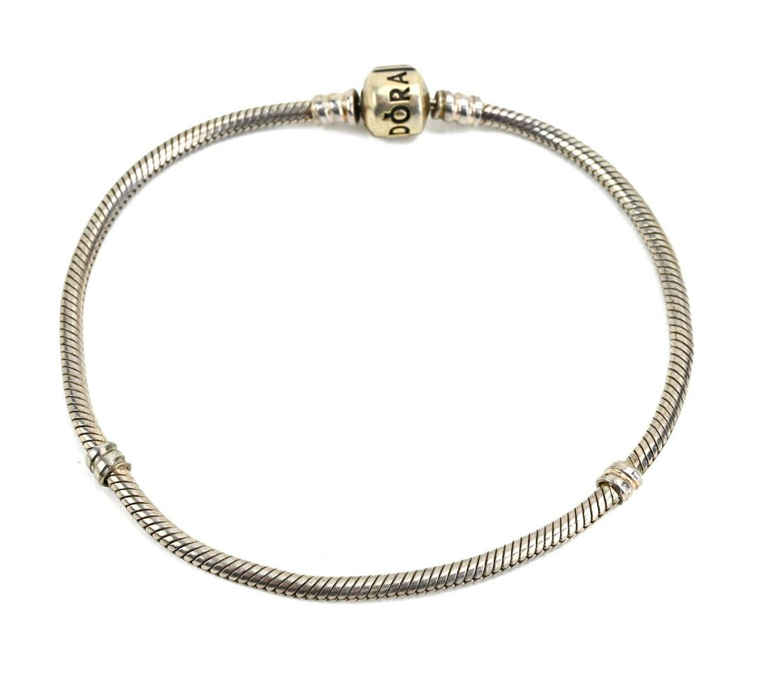 Sterling Silver Pandora Bracelet: Sterling Silver Pandora Bracelet. Measures 9 inches in length.