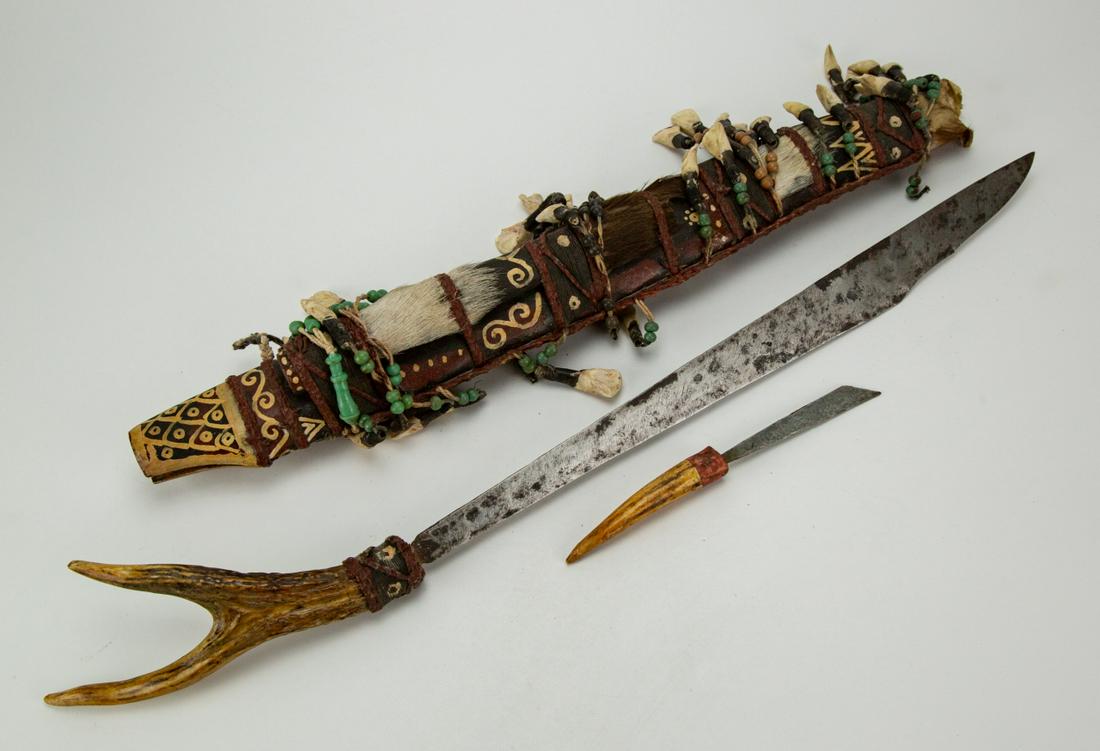 Antique African Sword / Dagger with Sheath: Antique African Sword / Dagger with Sheath, Animal Teeth Decorated. Measures 27 inches long