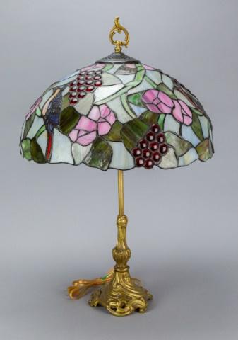 Art Nouveau Gilt Bronze Lamp w Stained Glass Shade: Art Nouveau Gilt Bronze Lamp w Stained Glass Shade.Shades feature cardinals, grapes and flowers.Base measures 25 inches x 6 inches diameter, shade measures 9 inches x 17 inches diameter.