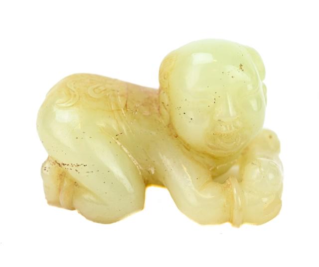 Qing Dynasty Smiling Boy on His Knees and Elbows: 19th Century Qing Dynasty Carved Smiling Boy on His Knees and Elbows. His head is turned to the right and he is holding a kitten. There is a tied ribbon carved on the boy’s back. The rich celadon ja