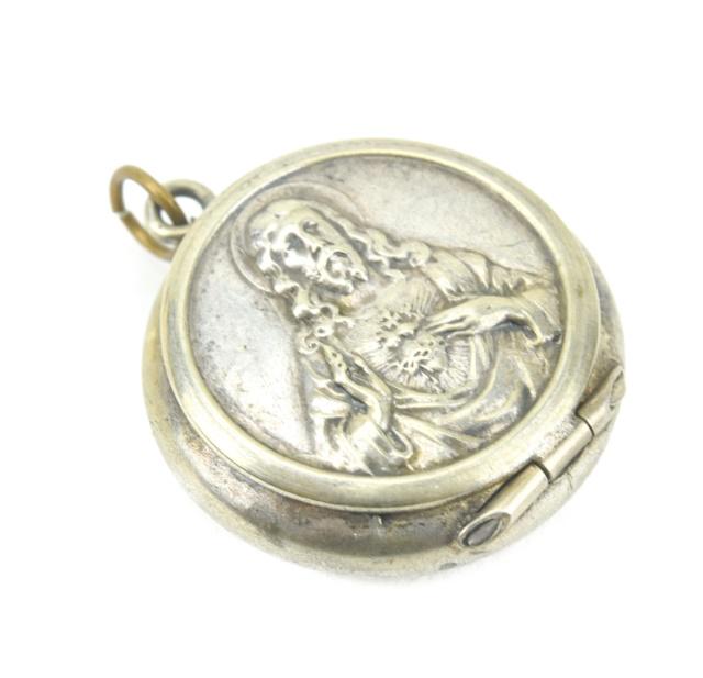 Antique Sterling Religious Locket w Sacred Heart: Antique Sterling Silver Religious Locket w Sacred Heart of Jesus Repousse on Front. Measures 1.25 inches in length.