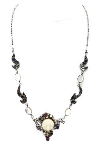 Man in the Moon Sterling Moonstone & Gem Necklace: Man in the Moon Sterling Moonstone & Gem Necklace. Having a hand carved bone man in the moon face with cabochon moonstones as well as pearl, amethyst and garnets. Measures 20 inches in length.