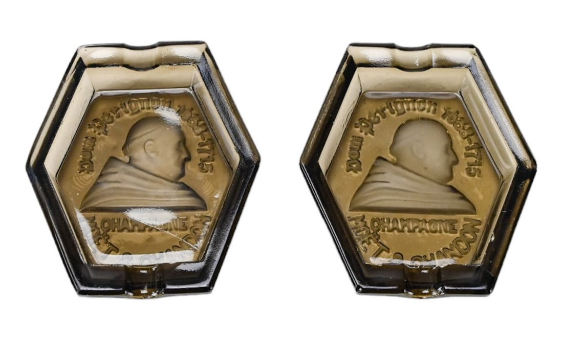 2 Vintage Dom Perignon Moet Chandon Ash Trays: 2 Vintage Dom Perignon Moet and Chandon Anniversary Intaglio Glass Ash Trays, France. Each measures 4.5 inches x 3.5 inches.