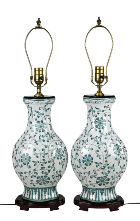 Pair Vintage Chinese Style Porcelain Lamps w Stand: Pair Vintage Chinese Style Hand Painted Green and White Porcelain Lamps on Carved Bases. Each measures 27 inches x 8 inches.