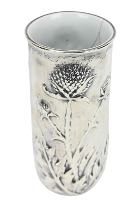 Edmond Tetard Art Nouveau Sterling Thistle Vase: Edmond Tetard Art Nouveau Sterling Silver With Porcelain Lining Thistle Flower of Scotland Motif Vase. Measures 9 inches x 4 inches in diameter. There are cracks in the porcelain lining. Vase is hallm