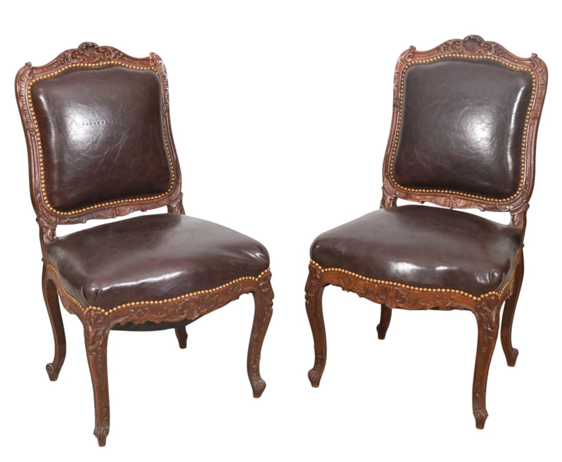 Pair Antique French Louis XV Style Carved Chairs: Pair Antique French Louis XV Style Hand Carved Leather Upholstered Chairs with Nail Head Trim Chairs. One Chair is Broken on Top, Needs Repair.Measures 37 inches x 21 inches x 19 inches, seat height 1