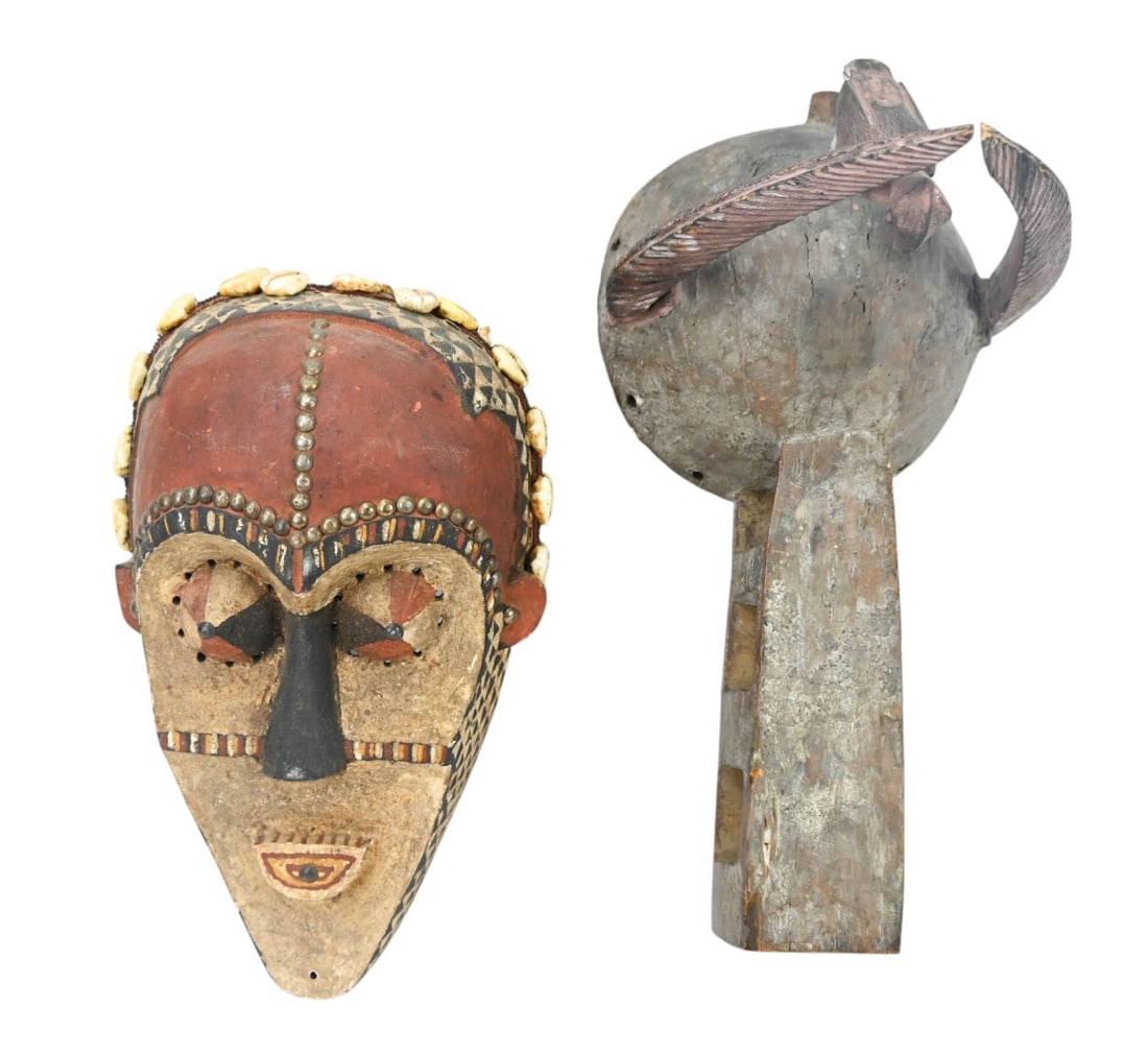 2 African Tribal Ceremonial Hand Carved Masks: 2 African Tribal Ceremonial Hand Carved Masks with Shell, Leather and Nail Head Trims.Largest measures 14 inches x 12 inches.