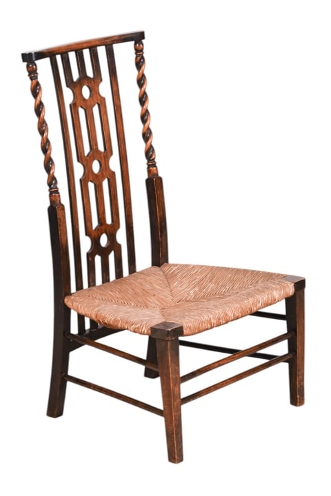 Antique English Carved Low Rush Seat Chair: Antique English Carved Low Rush Seat Chair. Measures 33 inches x 19 inches x 16 inches and 12 inches from floor to seat.
