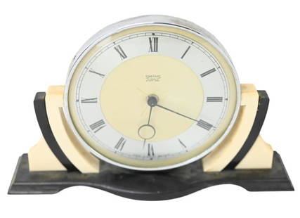 Smiths Art Deco Bakelite 8-Day Desk Clock: Smiths Art Deco Ivory and Black Bakelite 7-Day Desk Clock. Clock winding mechanism is working, but clock is missing pin to move arms and set clock. Clock measures 7 inches x 10 inches x 2 inches.