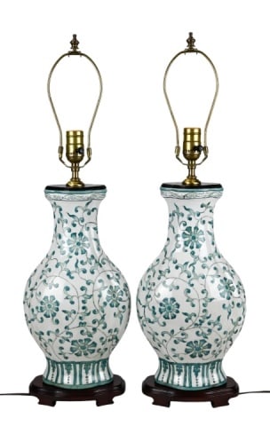 Pair Vintage Chinese Style Porcelain Lamps w Stand: Pair Vintage Chinese Style Hand Painted Green and White Porcelain Lamps on Carved Bases. Each measures 27 inches x 8 inches.