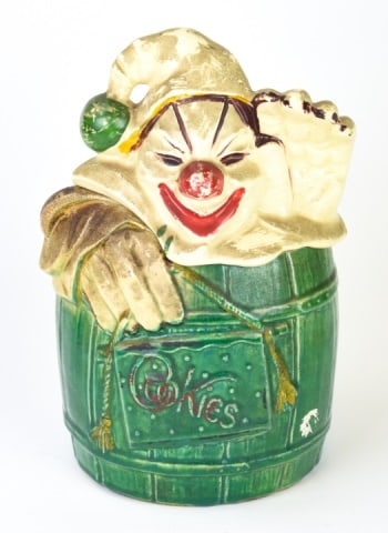 Vintage 1950s McCoy Clown in Barrel Cookie Jar: Vintage 1950s McCoy Waving Clown in Barrel Cookie Jar. Measures 11 inches high x 6.5 inches wide x 5.5 inches deep. The dark color is dirt that can be removed. Sold as is.