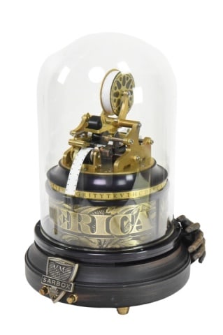 Sam Zell "Sarbox" Music Box Ticker Tape Automation: Sam Zell "Sarbox" Music Box Ticker Tape Automation. This machines features a solid brass ticker tape assembly under a glass dome and is engraved with phrases like Honesty, Integrity and Truth.Measures