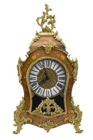 Italian Franz Hermle Le Ore Mantel Clock: Italian Boulle Style Franz Hermle Le Ore Mantel Clock. The clock features an 8 day mechanical movement with analog display using roman numerals and intricate gildxed details and floral inlays. Please 