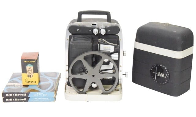 Bell & Howell Lumina 12 Projector w/ Accessories: Bell & Howell Lumina 12 Projector with Accessories.Projector measures 12 inches x 8 inches squared. Accessories include two 8mm 400ft can and True-Flector Lens. In original box.
