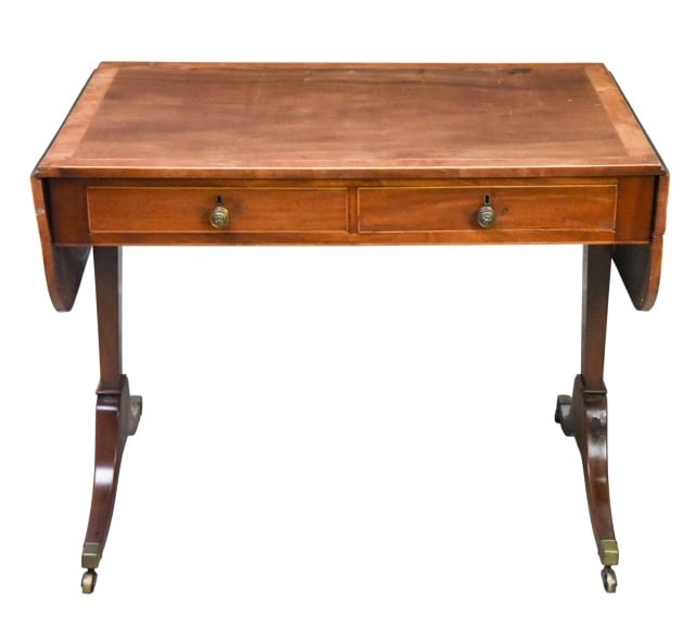 Antique Georgian Style Drop Leaf Writing Desk: Antique Georgian Style Drop Leaf Writing Desk. Rectangular top with rounded drop leaves, dual frieze drawers, and splayed legs on brass-capped castors.Measures 28 inches x 36 inches x 25 inches.Measur