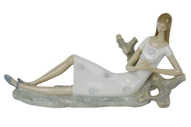 Lladro Porcelain Reclaining Girl Daisy Figurine: Lladro Porcelain Reclining Girl Daisy Figurine. Arm has been repaired. Sold as is.Measures 8 inches x 16 inches.