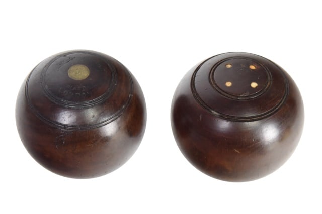 Pair Antique Lignum Vitae Wood Lawn Bowls: Pair Antique Lignum Vitae Wood Lawn or Carpet Bowls Featuring Carved Concentric Rings and Inlaid Bone.Measure 5 inches in diameter. One Ball is marked Taylor Rolph Co LTD, BIAS London, IMP BRAND.