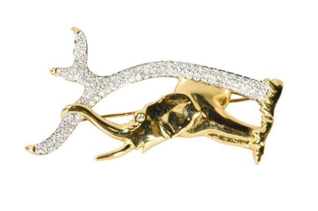 Swarovski Crystal Gold Toned Elephant Brooch: Swarovski Crystal Gold Toned Elephant Brooch with Paved Crystal Branch.Measures 1 inch x 3 inches.