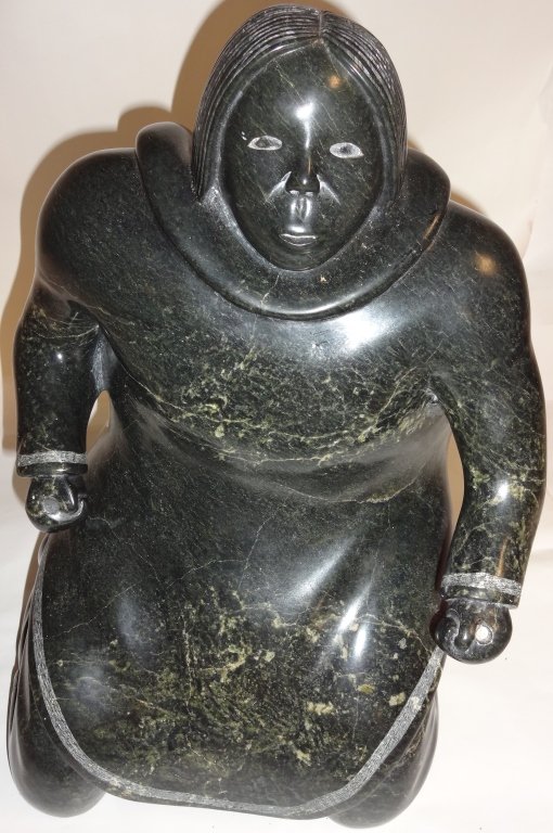 Vintage Inuit Stone Statue- Seated Woman: Vintage Inuit stone statue of seated woman. One small chip, 12 1/4" L x 11" W x 15 1/2" H. From the home of Mary Rockefeller.