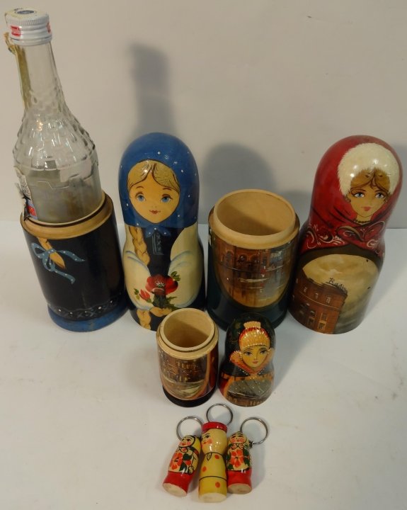 Lot of Hand-Painted Lacquered Matryoshka Dolls: Two large hand painted/lacquered Matryoshka dolls. The red doll has one nesting twin but is not a full set. The other, a girl with blonde braid, conceals a Russian vodka bottle. 3 1/4" dia. x 13" H. T